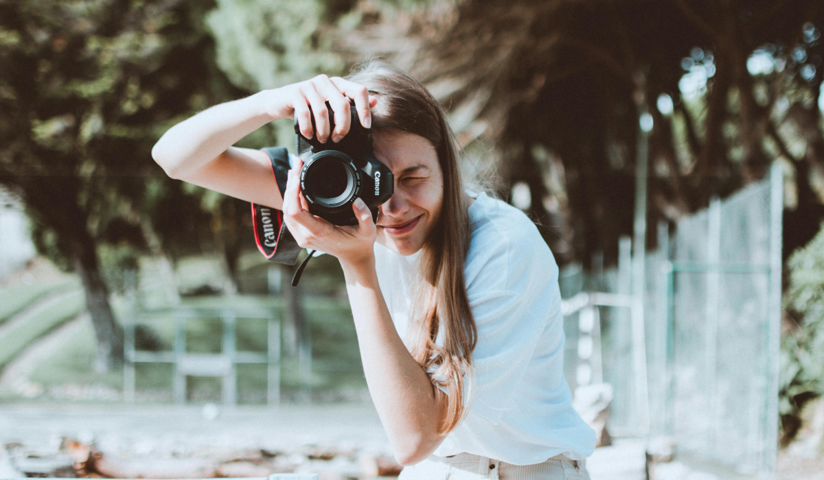 Woman using canmera pointed at viewer